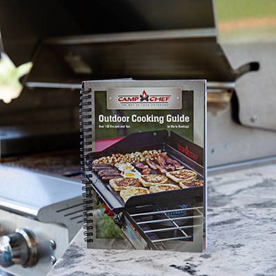 CAMP CHEF<sup>&reg;</sup> Outdoor Cookbook - This outdoor cooking guide is filled with over 100 recipes and tips to have you cooking like a pro.  Whether you love patio cooking, tailgating, barbecuing or camping, there are dozens of easy-to-follow recipes in this cookbook.  